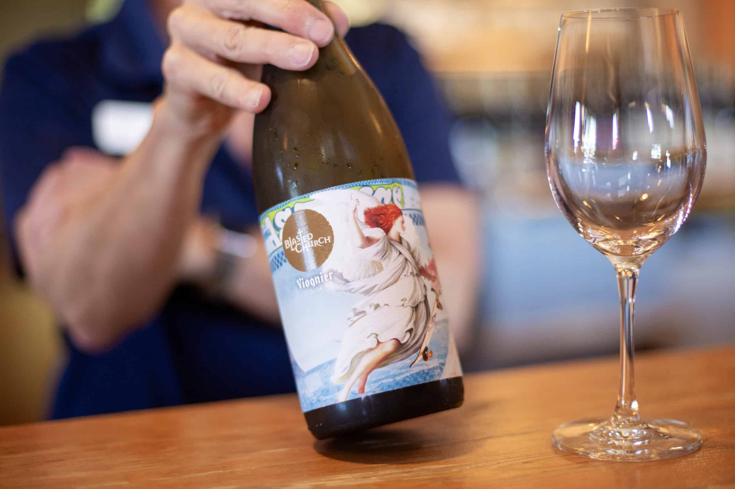 A bottle of Blasted Church Viognier 2024 is displayed in the wine shop