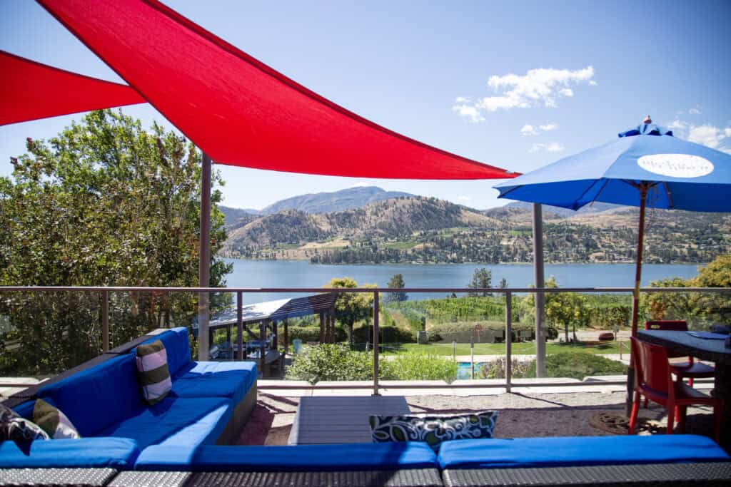 Lake, mountain and vineyard views from the comfortable patio area of Blasted Church Vineyards