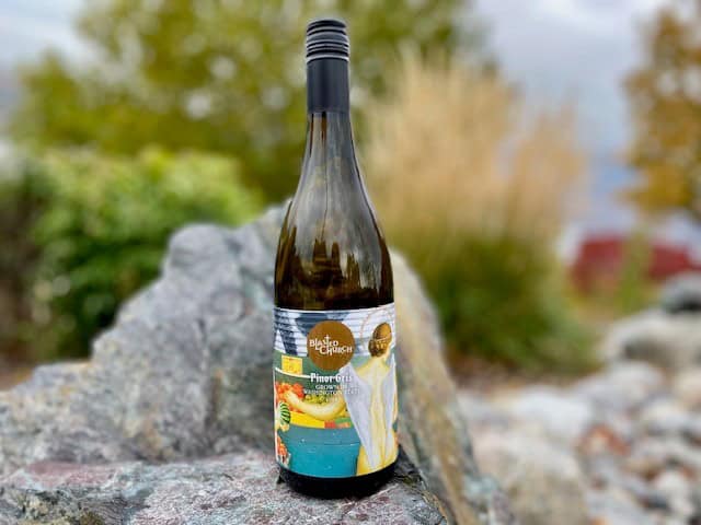 Blasted Church Pinot Gris is displayed in a rock garden