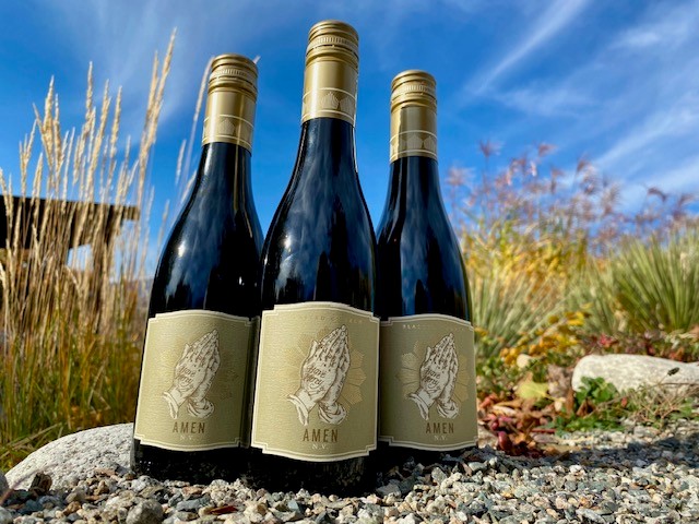 Blasted Church Amen fortified wine photographed in a rock garden in the fall