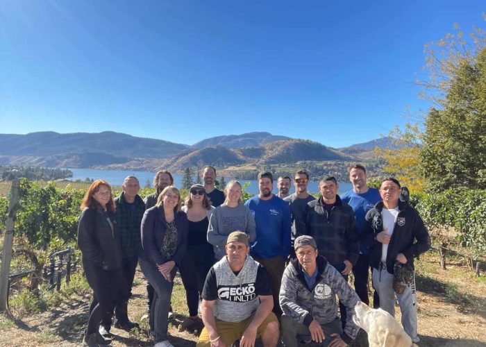 Team Blasted Church group photo with vineyard views